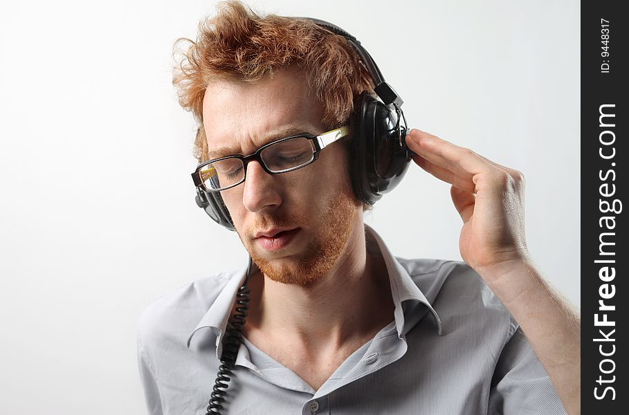 Funny guy listening music with earphones