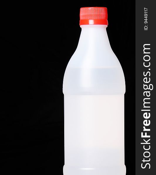 Plastic bottle on black background. Copy space