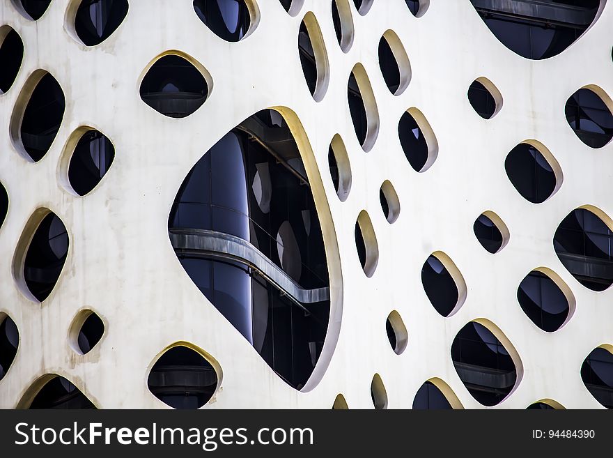 A close up of a modern building facade with holes.