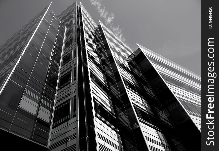 A monochrome of a high rise office building from a low angle.