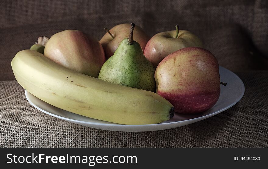 Fruit plate on the table on a background of linen fabric. Fruit plate on the table on a background of linen fabric