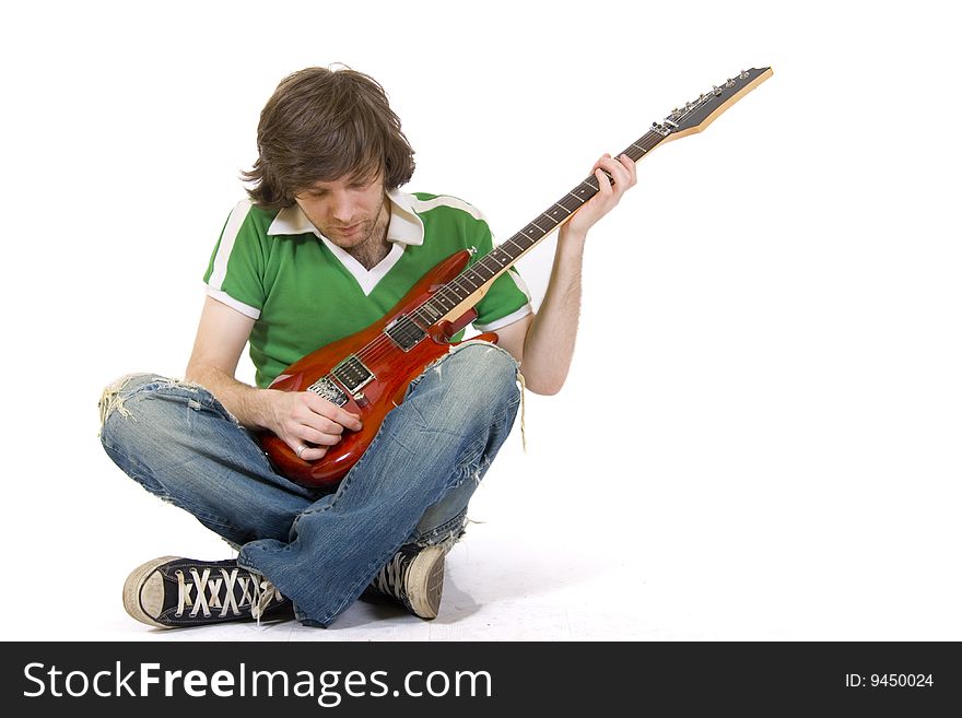 Guitarist calibrating his electric guitar. Guitarist calibrating his electric guitar