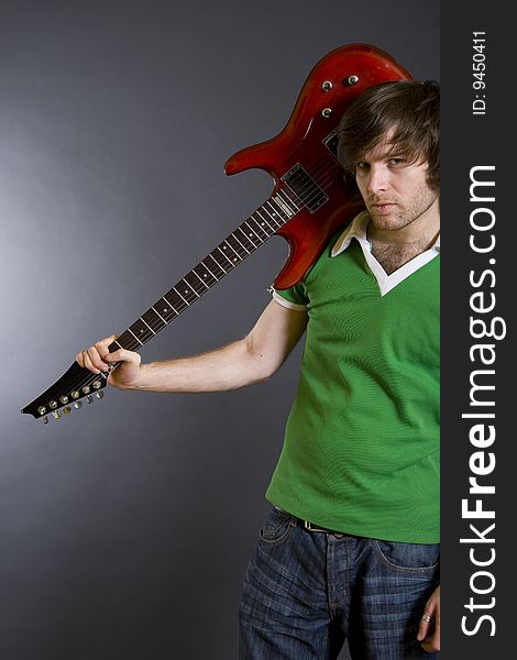 Man Holding His Guitar On Shoulder