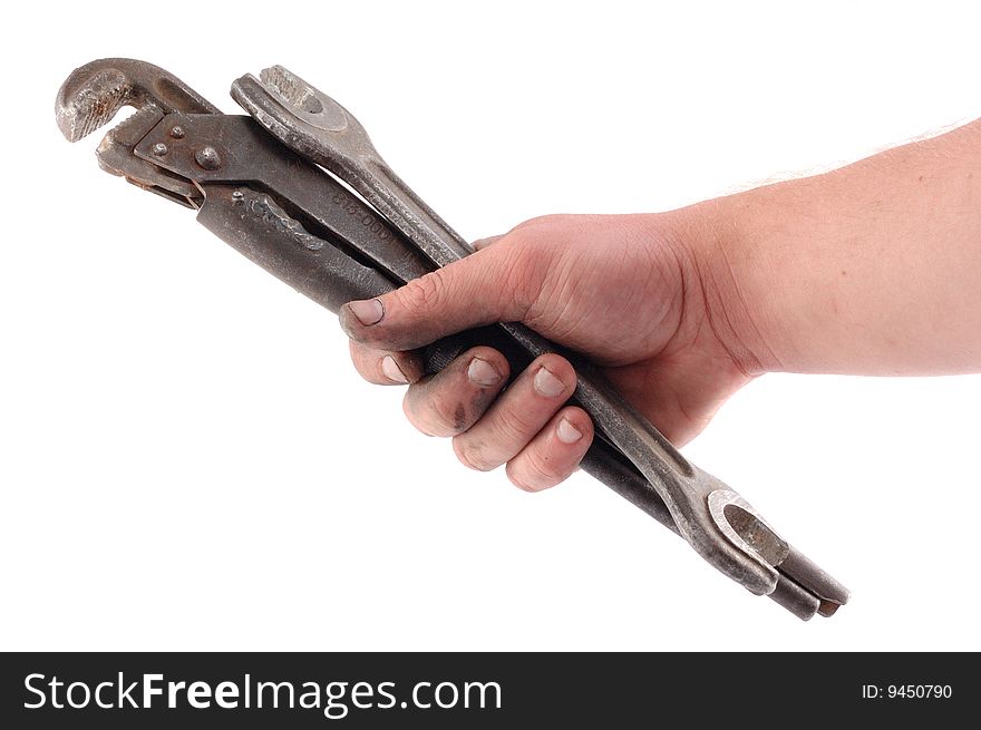 A metallic wrench is in a hand