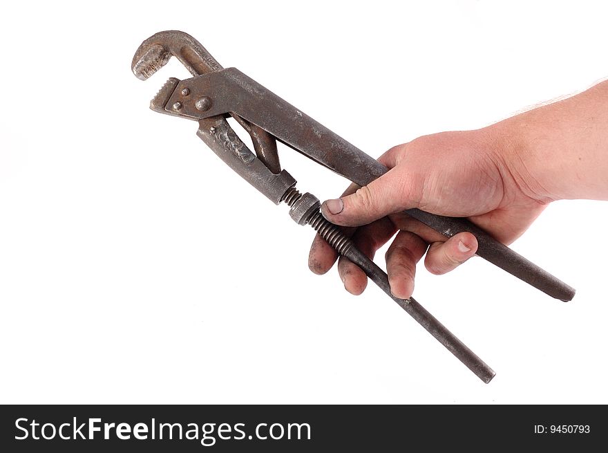 A metallic wrench is in a hand