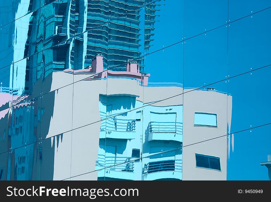 Reflection of a building in glass wall of an office building