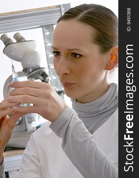 Woman doctor with syringe in the laboratory