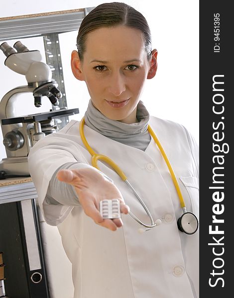 Female doctor showing medications into the camera. Female doctor showing medications into the camera