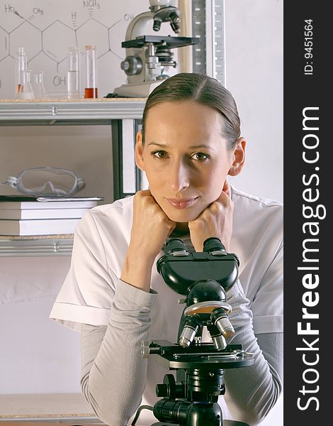 Scientist woman works with microscope in the laboratory. Scientist woman works with microscope in the laboratory