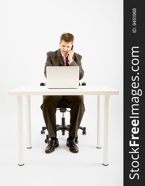 Young businessman working with phone and laptop computer