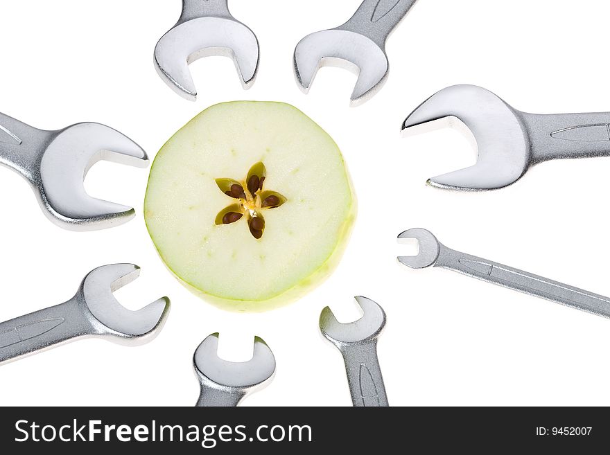 Cut apple and wrench isolated. Clipping path. Cut apple and wrench isolated. Clipping path