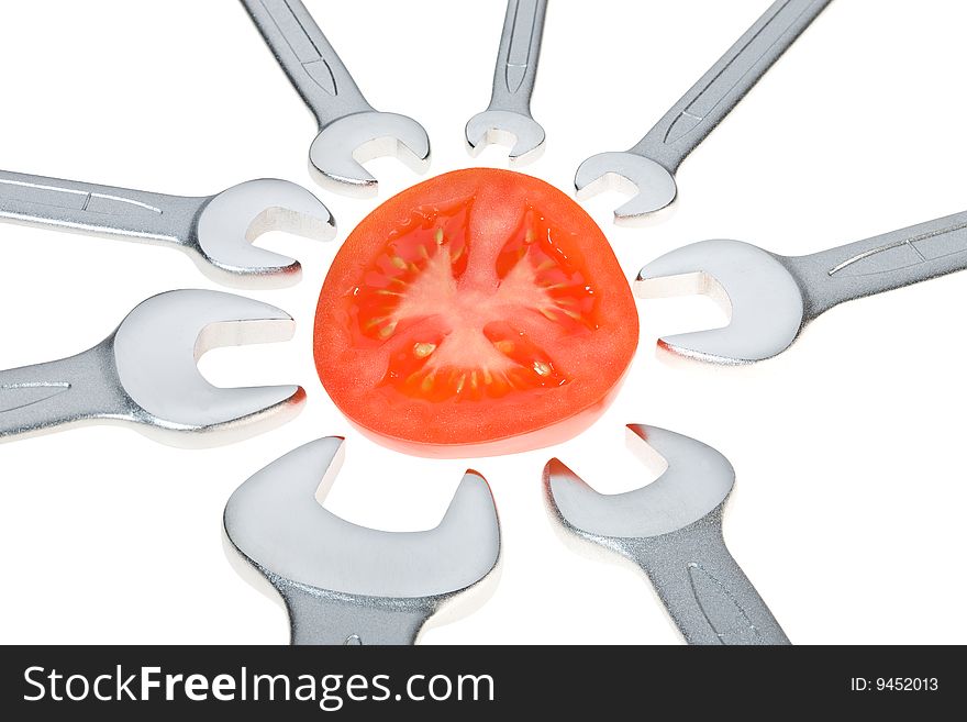 Cut tomato and wrench isolated. Clipping path. Cut tomato and wrench isolated. Clipping path