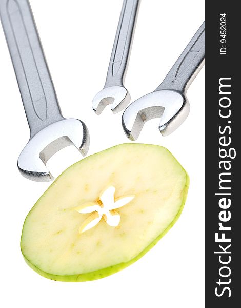 Cut apple and wrench isolated. Clipping path. Cut apple and wrench isolated. Clipping path