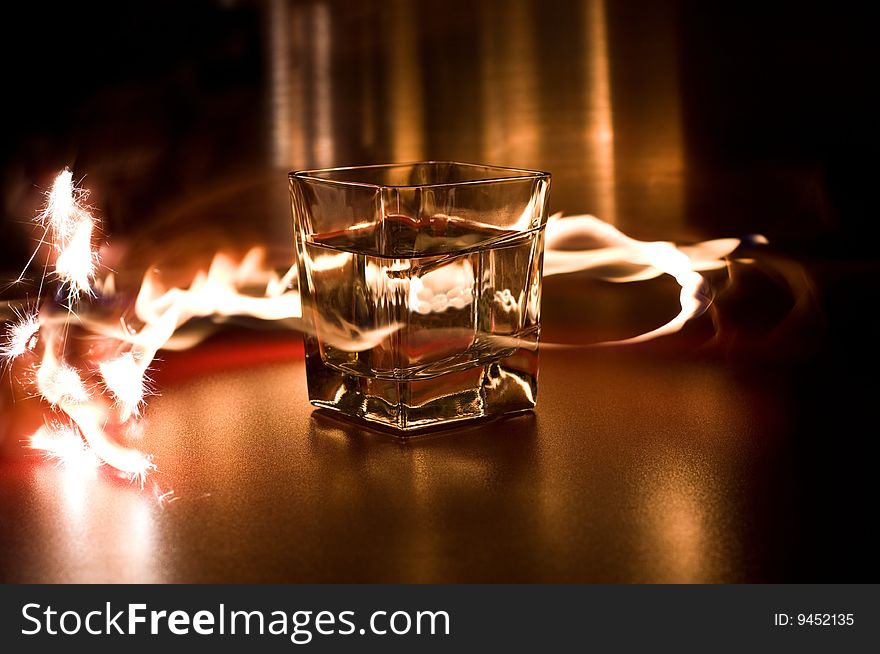 Glass with water between the flames. Glass with water between the flames