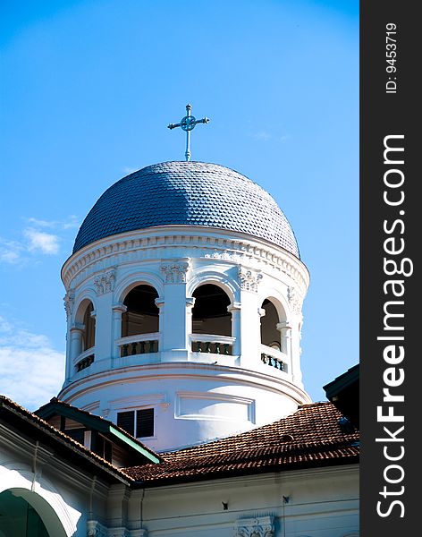 White church roof exterior against blue sky