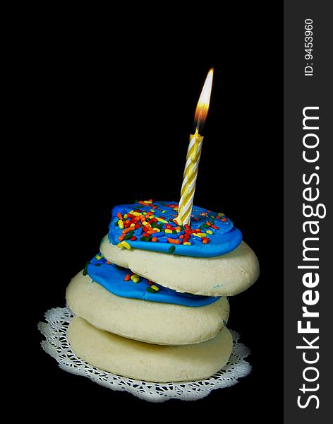 Birthday candle in a stack of sugar cookies. Birthday candle in a stack of sugar cookies.