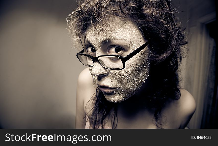 Close-up portrait of funny girl with facial mask.