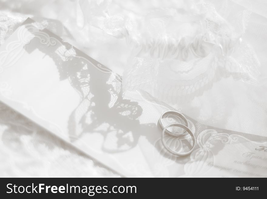 Black-and-white photo of wedding rings in an environment of laces. Black-and-white photo of wedding rings in an environment of laces