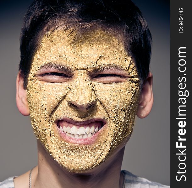 Close-up portrait of funny man with facial mask and glasses