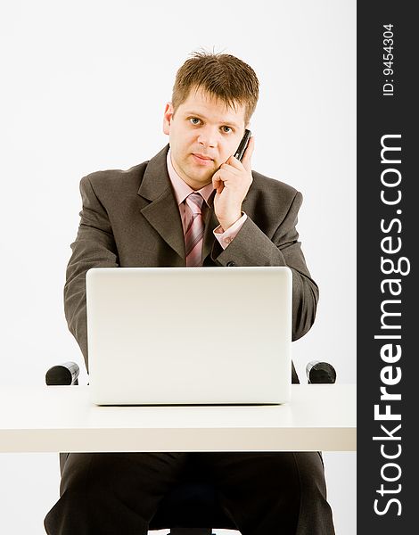 Young businessman working with phone and laptop computer