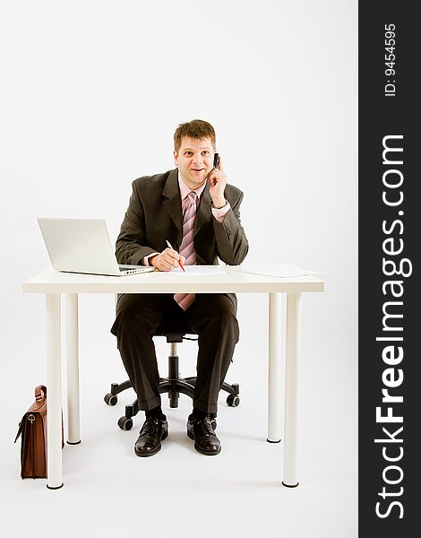 Young businessman working with phone and laptop computer