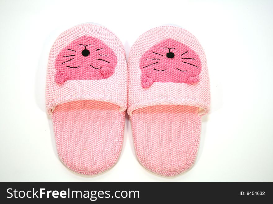 Funny pink slippers on the white background. Funny pink slippers on the white background