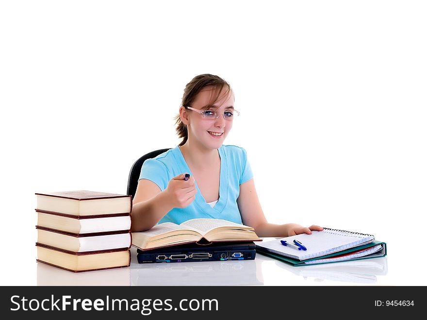 Happy smiling teenager girl on desk doing studying and homework