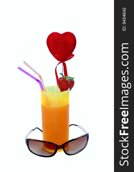 Glass filled with refreshing juice garnished with a strawberry and heart, white background. Glass filled with refreshing juice garnished with a strawberry and heart, white background