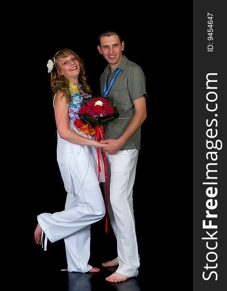 Young happy laughing wedding couple on black background, studio shot. Young happy laughing wedding couple on black background, studio shot