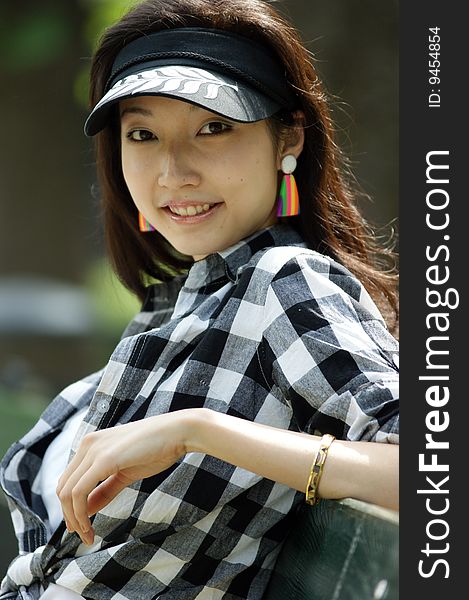 A Portrait of a young Asian woman with a summer hat