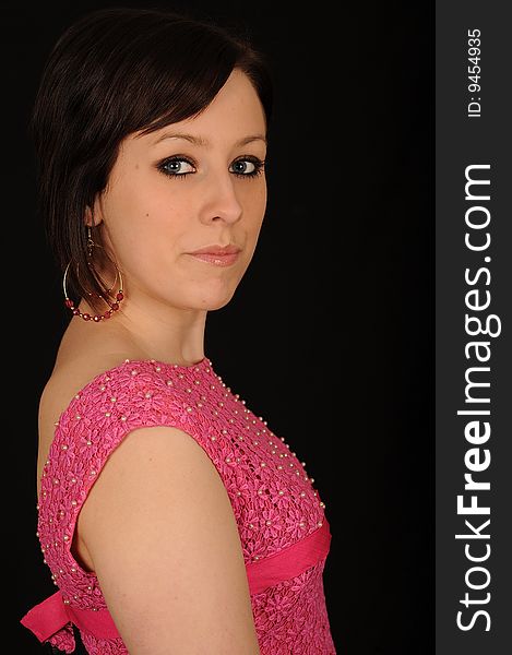 Horizontal closeup portrait of a smiling young woman, isolated against a black background. Horizontal closeup portrait of a smiling young woman, isolated against a black background.