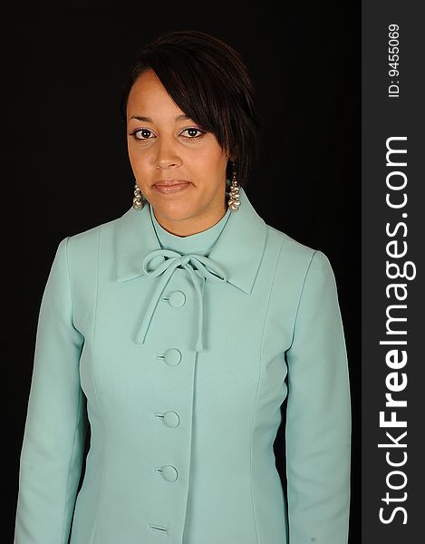 A closeup portrait of a pretty African American teenage woman.  Black background. A closeup portrait of a pretty African American teenage woman.  Black background