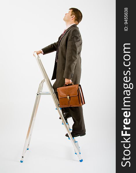 Business man with ladder on a white background