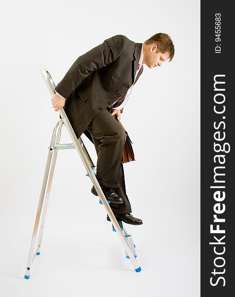 Business man with ladder on a white background