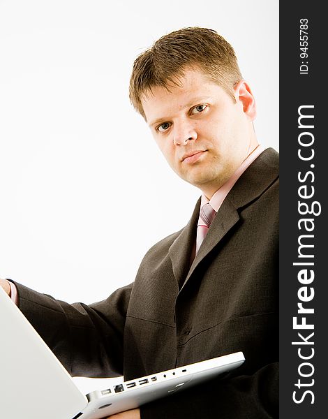 Young business man with laptop computer on white background
