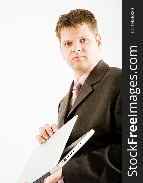 Young business man with laptop computer on white background