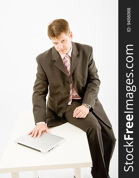 Young business man with laptop computer on white background