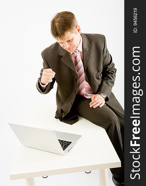 Young business man with laptop computer on white background