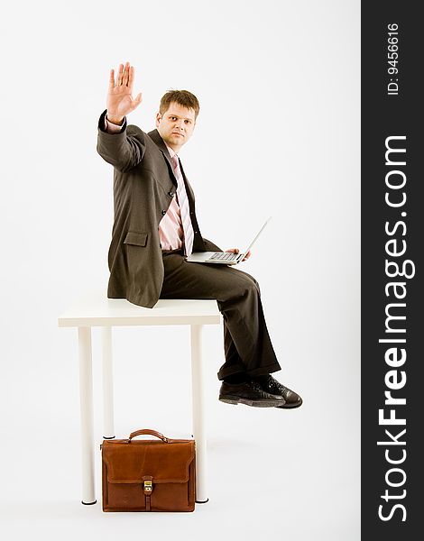 Young business man with laptop computer on white background