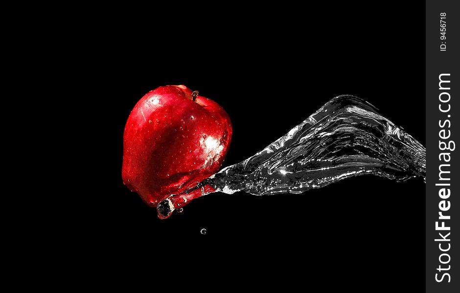 Red apple in water stream