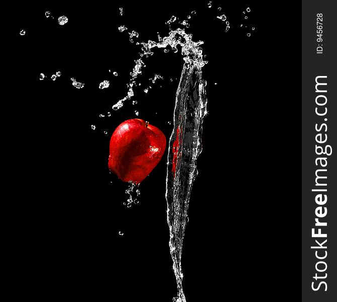 Red ripe apple in water stream. Red ripe apple in water stream