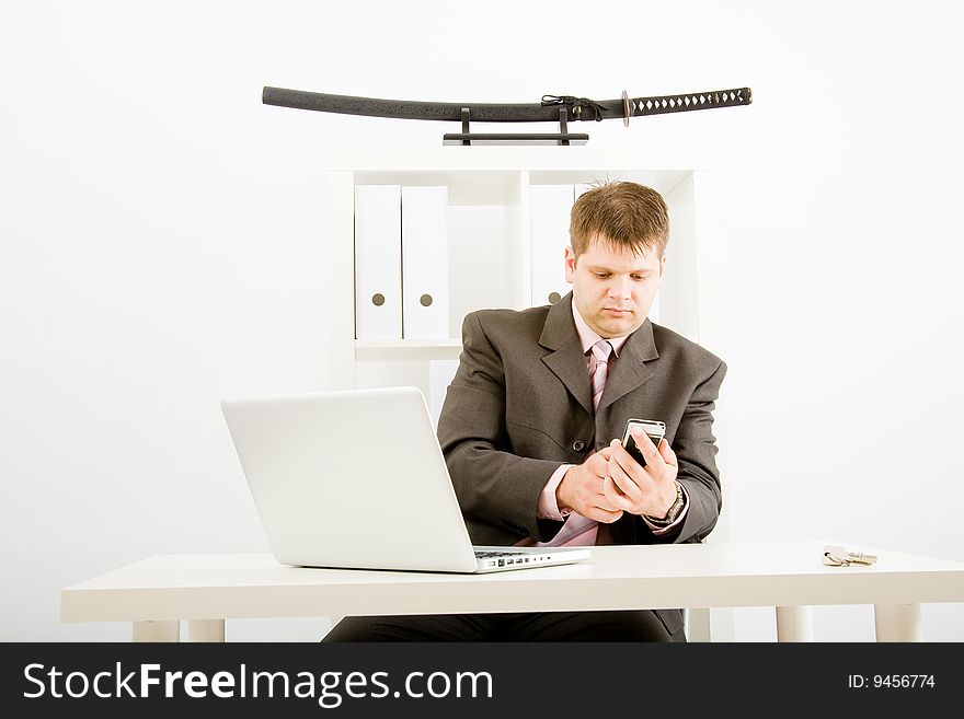 Young businessman working with phone and laptop computer