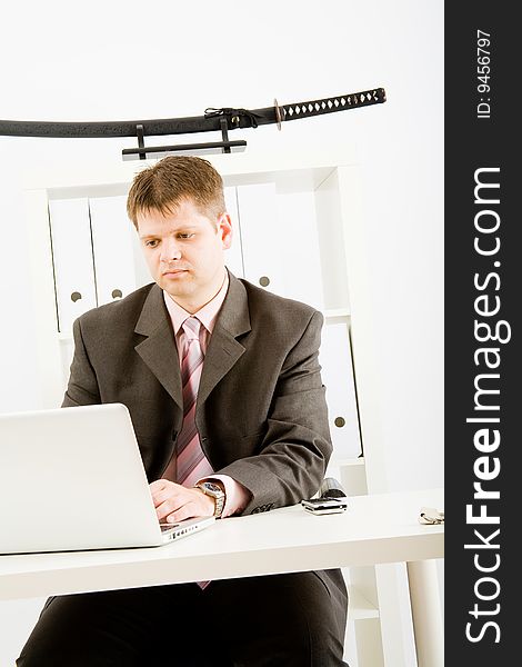 Young businessman working with phone and laptop computer