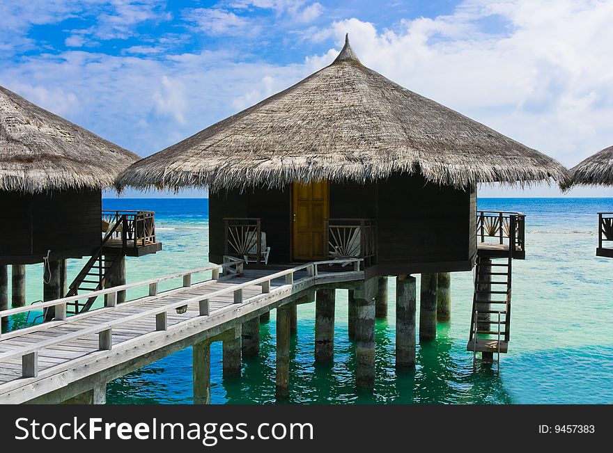 Water bungalows at a tropical island - travel background