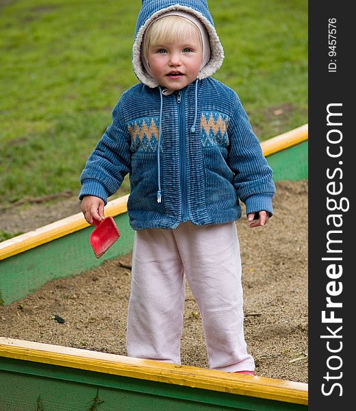 Little child stands with shovel. Little child stands with shovel