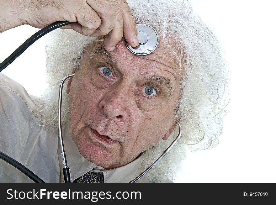 Older man checking his head with a stethoscope