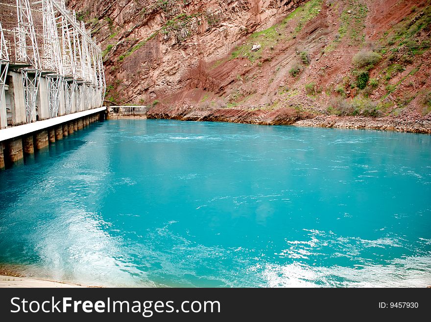 Water basin with blue water in red mountains. Water basin with blue water in red mountains