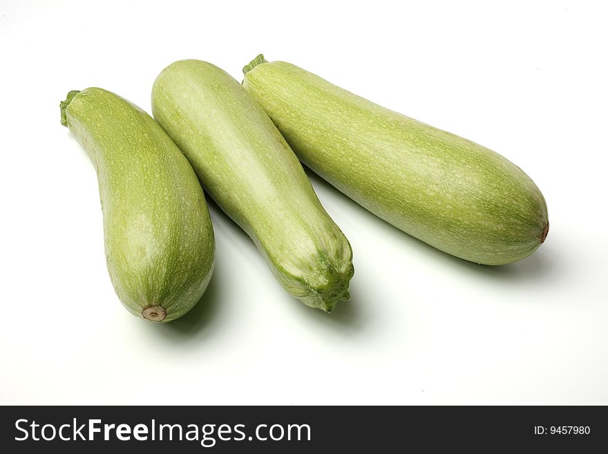 3 fresh courgettes on white isolated background.