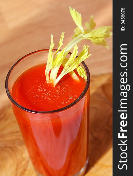 Tomato juice in a glass with a celery