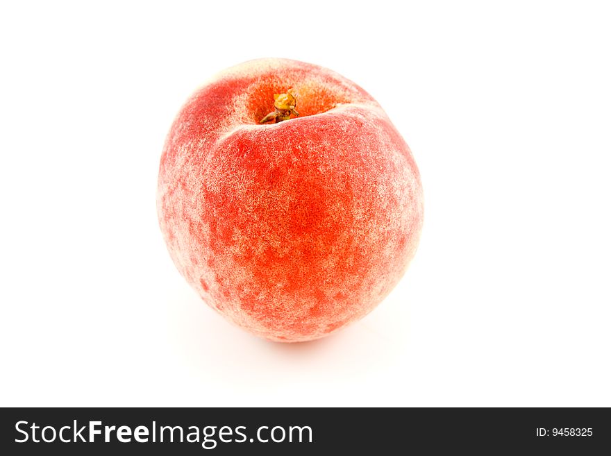Single red ripened peach with a short stalk on a white background. Single red ripened peach with a short stalk on a white background